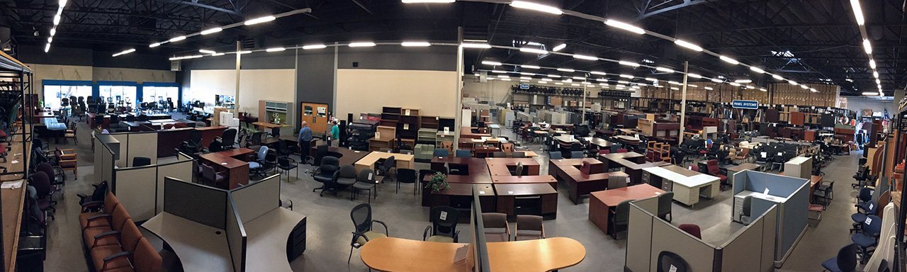 A close-up view of a professional pre-owned office desk surface in a warehouse.