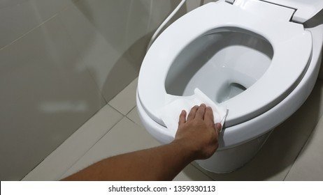 Cleaning supplies like a microfiber cloth and soap solution arranged on a bathroom vanity.