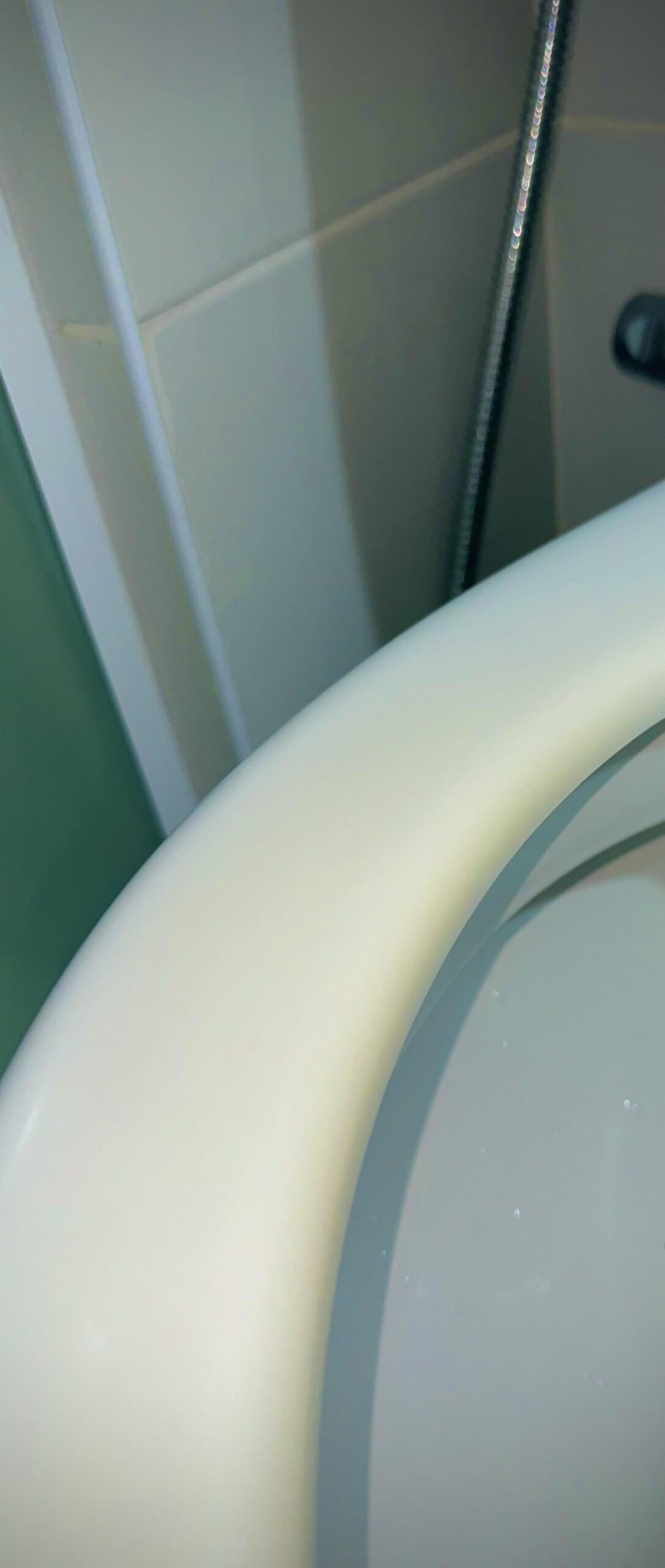A bowl of baking soda paste used for cleaning a stained toilet seat.