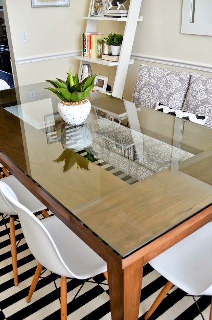 Modern glass coffee table decorated with unique sculptural accents and art books.