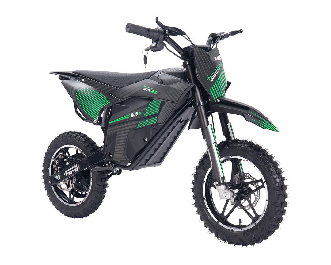 A dirt bike parked in a workshop showing the rear tire assembly.