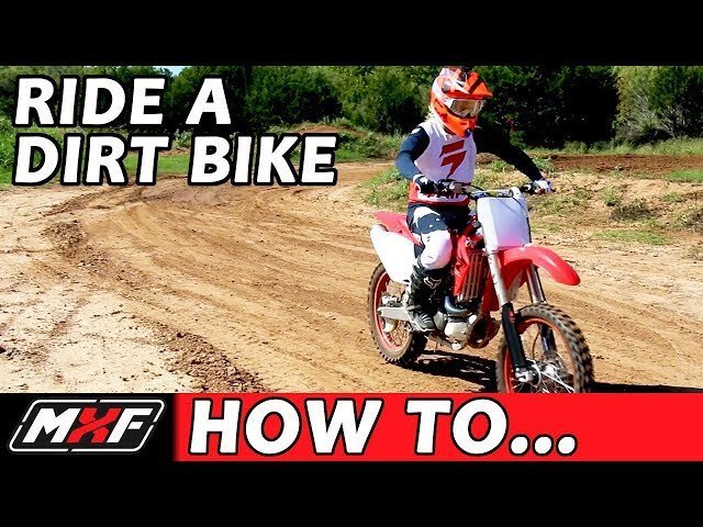 Essential safety gear for dirt bike riding is organized on a workbench.
