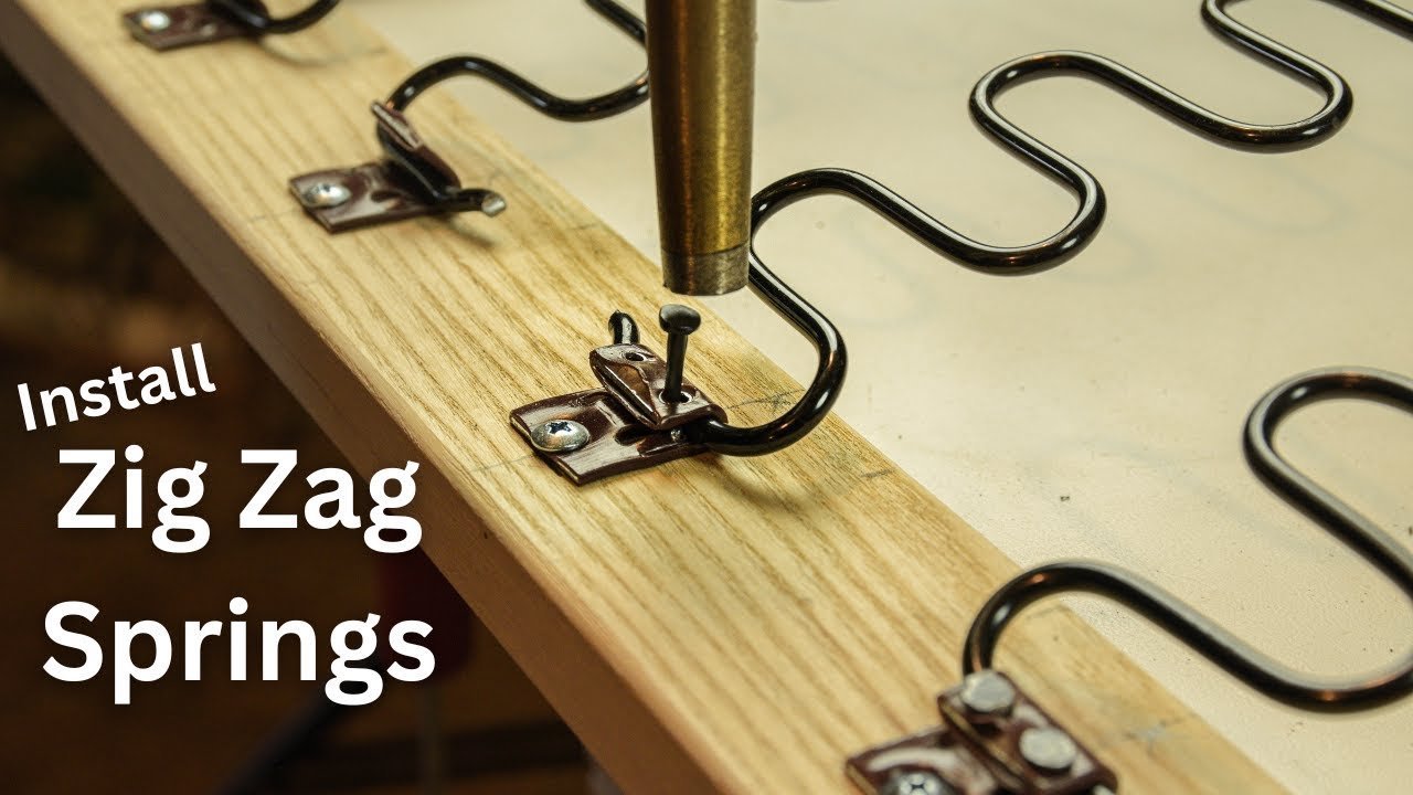 Hands securing synthetic upholstery webbing to a chair frame with staples.