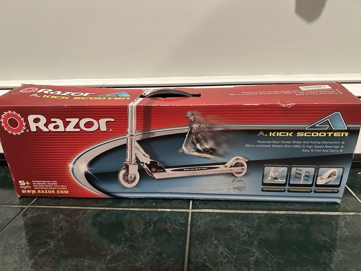 A secure, folded kick scooter being lifted to test the hinge stability.