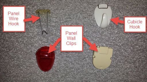 Hands carefully securing a document to a cubicle wall using a T-pin.