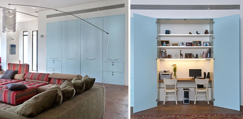 A decorative folding screen creating a private home office in a living room.