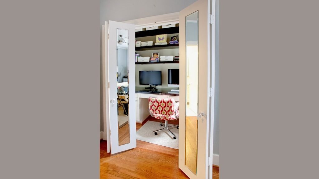 A clean living room with a hidden home office tucked inside a cabinet.