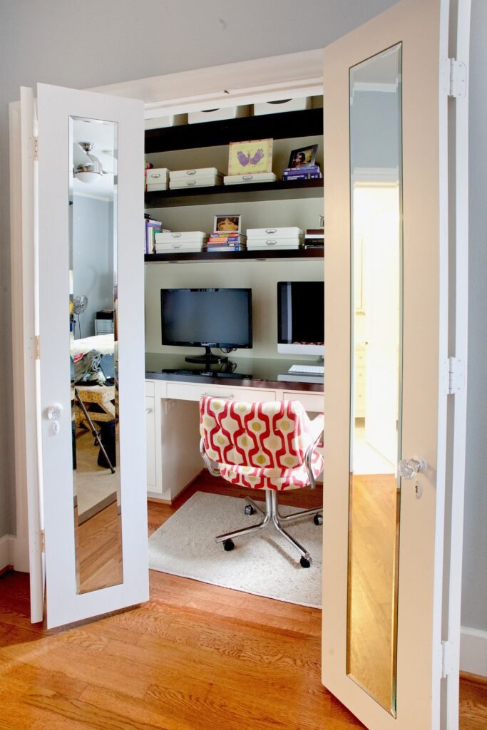 A clean living room with a hidden home office tucked inside a cabinet.