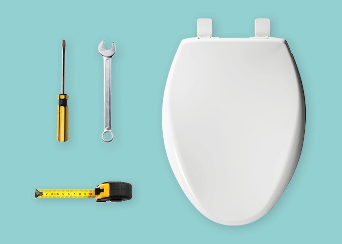 Measuring a toilet bowl to ensure the correct size for a new seat.