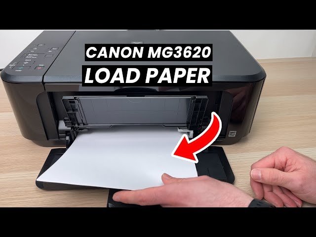 A stack of white printer paper prepared for loading into a printer.