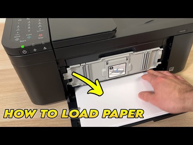 Loading a sheet of paper into the rear feed slot of a printer.