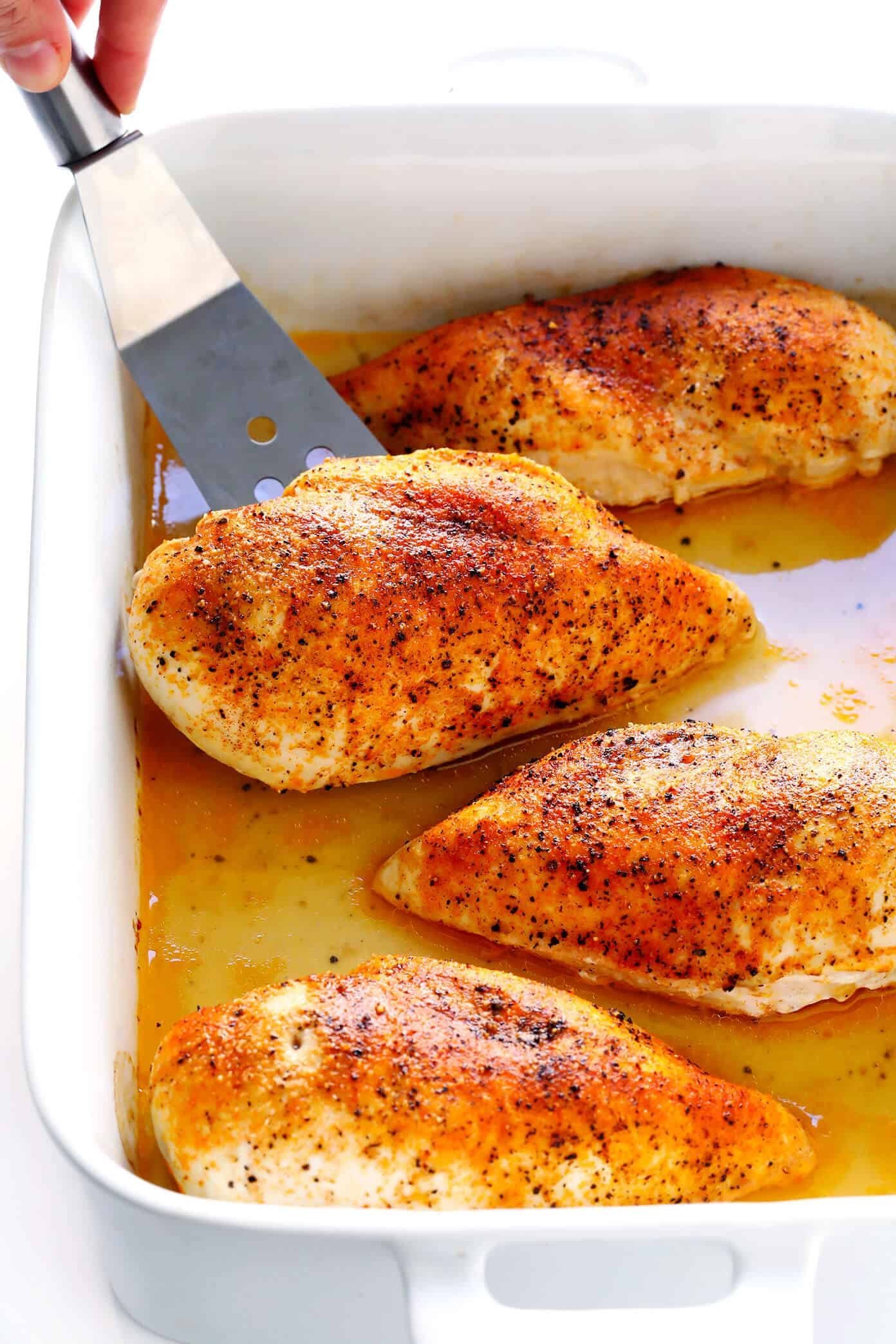 A close up of a roasted chicken showing perfectly cooked meat texture.