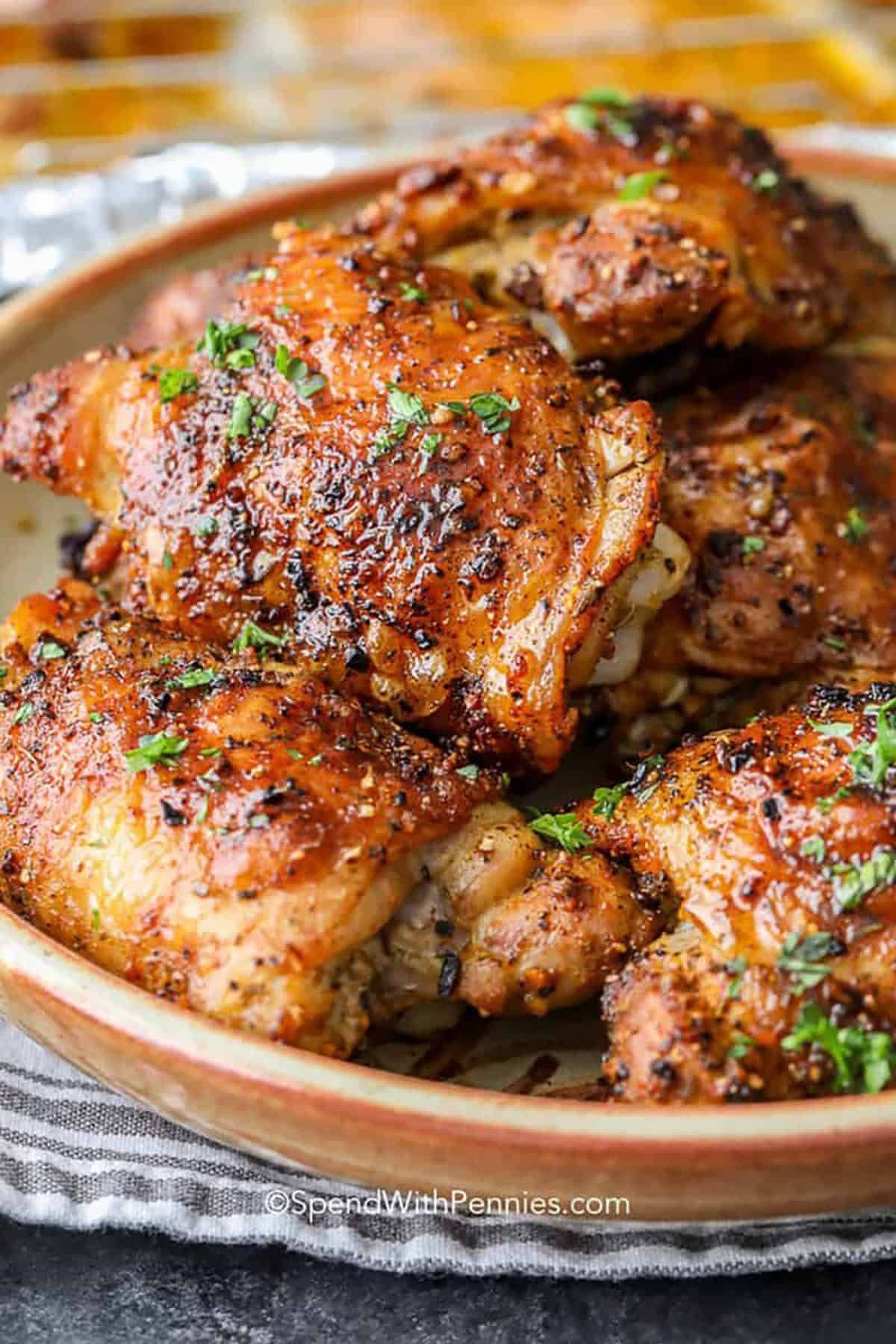 Kitchen tools for roasting chicken including a thermometer and roasting rack.