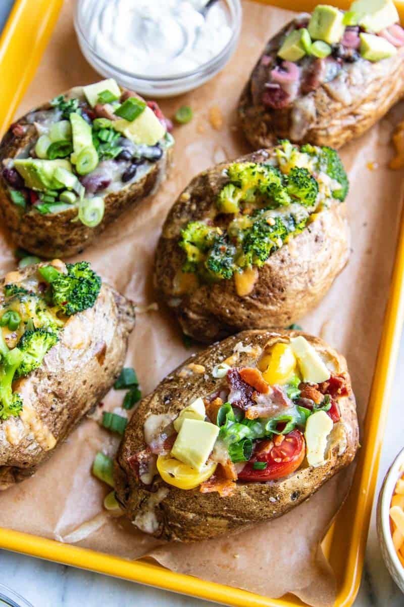 A notebook and a baked potato representing common questions about cooking jacket potatoes.