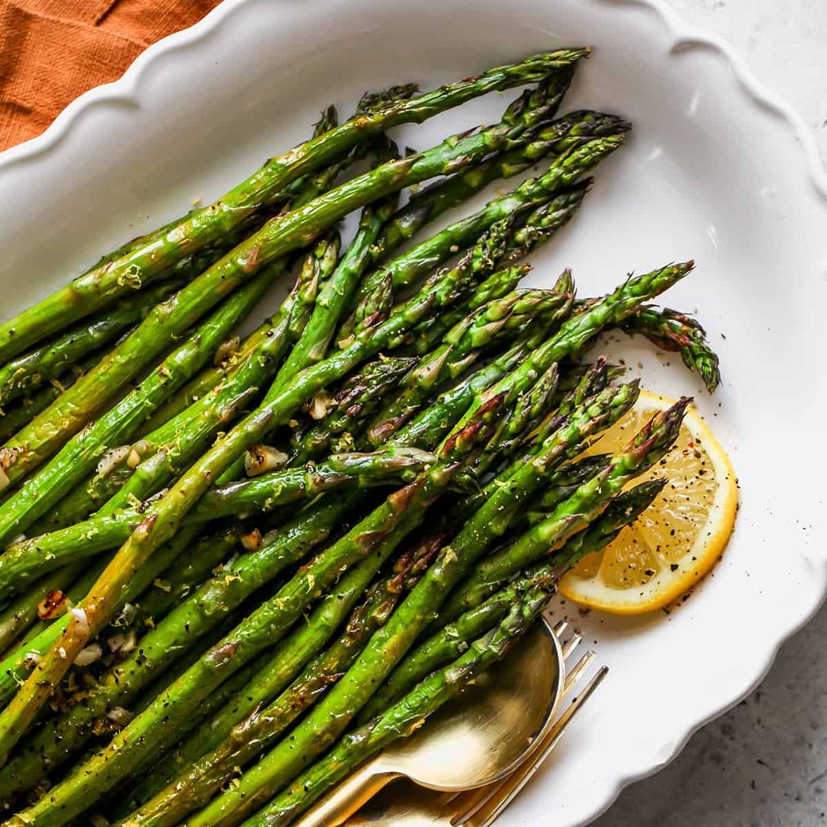 Close-up of roasted asparagus stalks showing varied levels of char and texture.