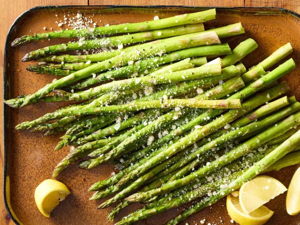 A delicious platter of perfectly oven roasted asparagus seasoned with lemon and parmesan.