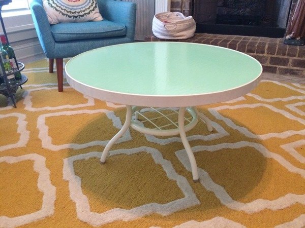 Carefully taping the edges of a glass table top before applying paint.