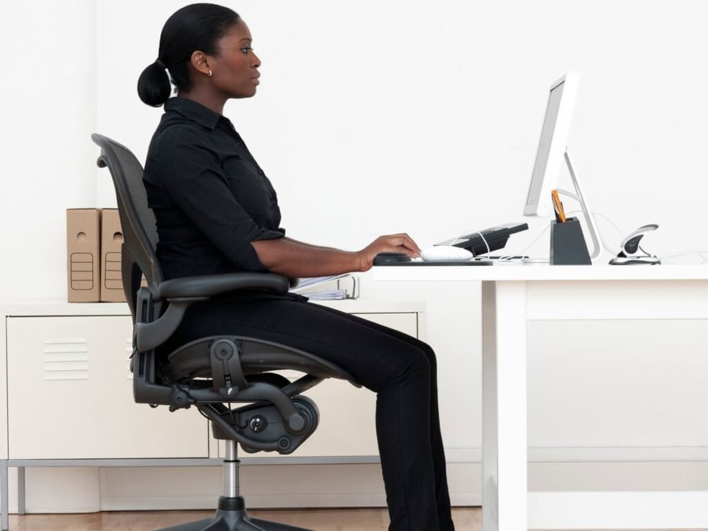 An ergonomic office chair perfectly positioned in a clean, bright, modern home office.