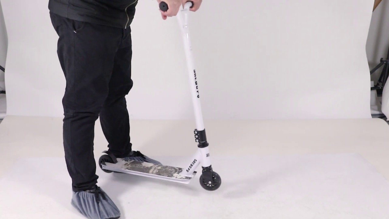 A clean workspace showing a scooter and a manual for answering assembly questions.