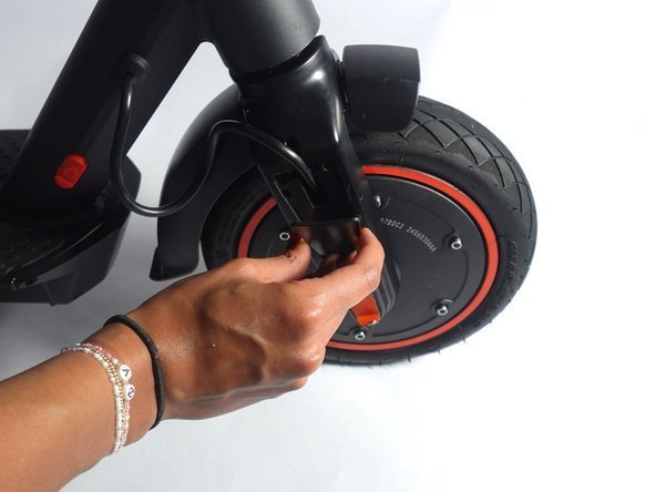 Essential tools for removing a scooter wheel laid out on a clean surface.