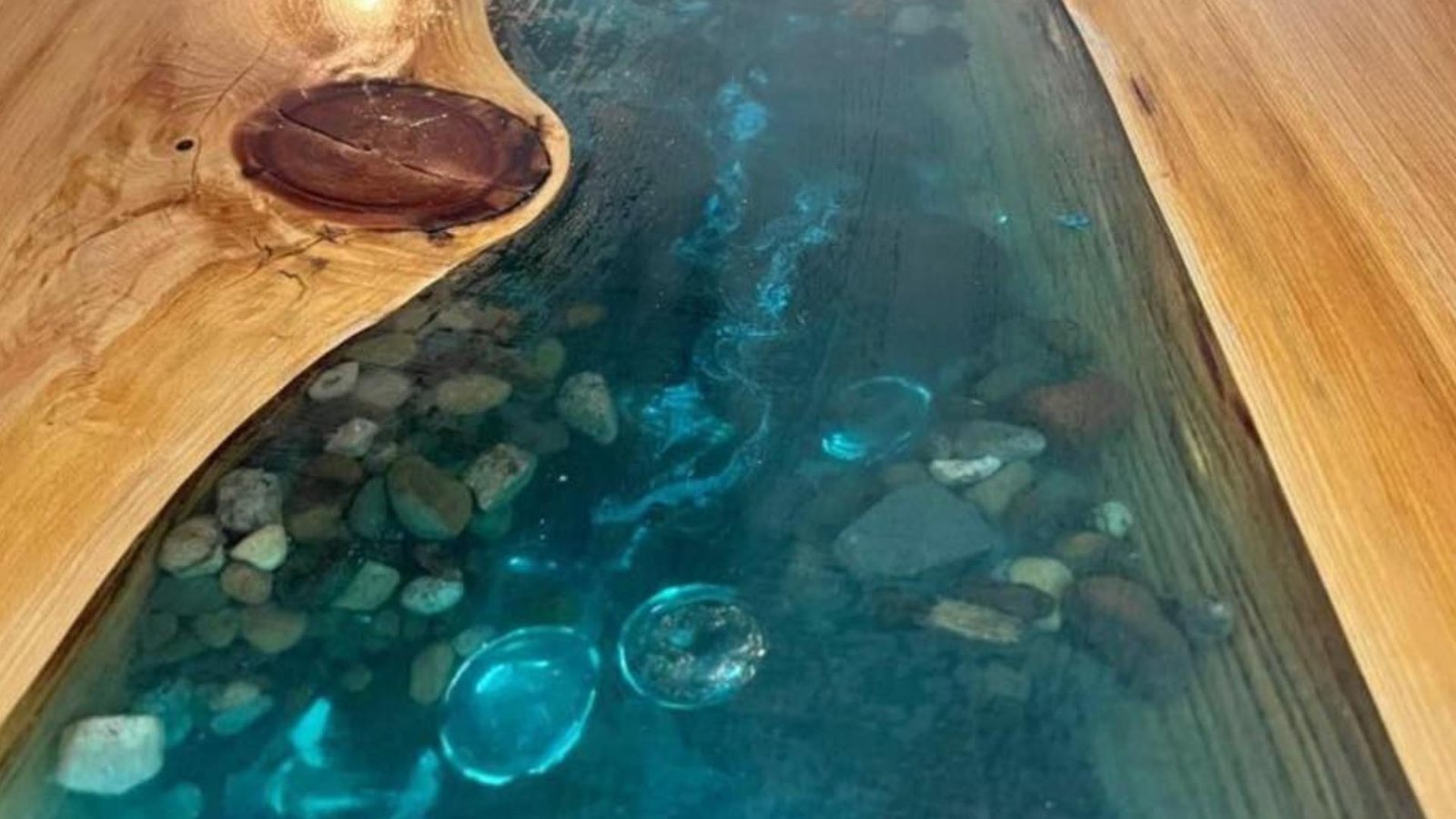 Close up of scratches and heat damage on an epoxy resin table surface.