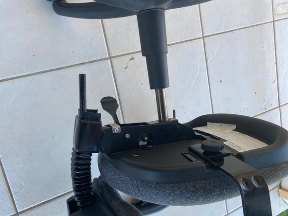 Applying penetrating oil to the metal base of an office chair.