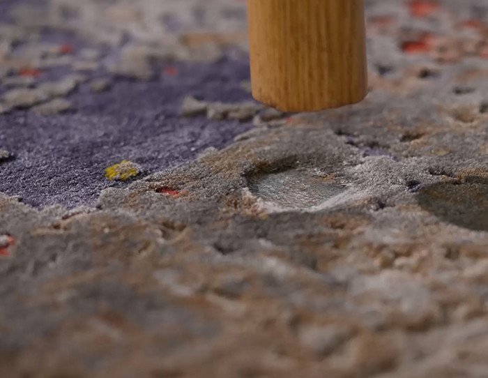 High moisture levels causing visible bumps in residential carpet backing.
