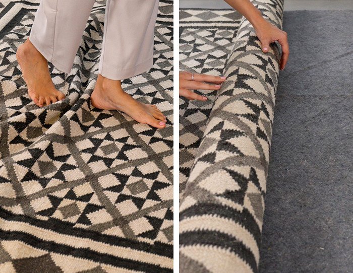 Using a knee kicker tool to remove a bump from carpet fibers.