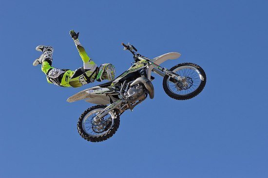 Close-up detail of a dirt bike front tire engaging on a trail.