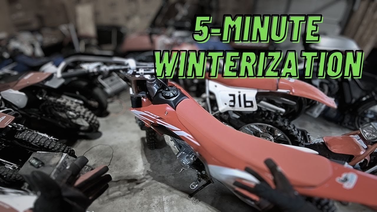 Essential tools and fluids for winterizing a dirt bike laid out on a workbench.