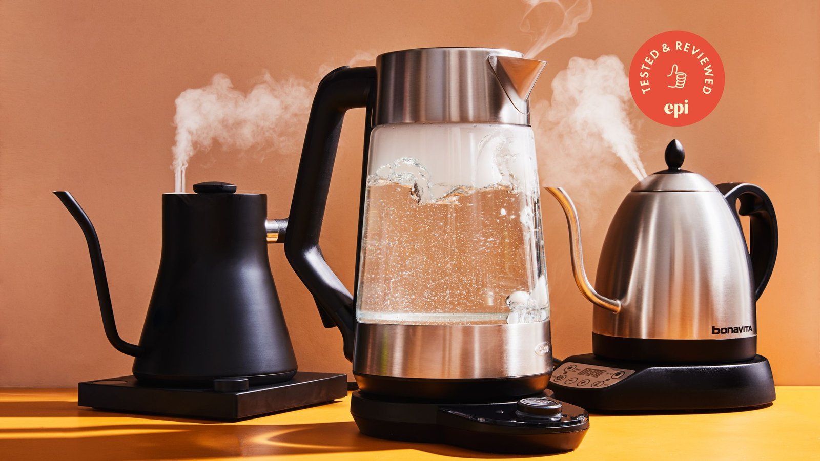 A modern electric kettle heating water on a clean marble kitchen countertop.