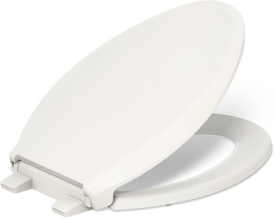 A modern Kohler Cachet toilet seat with a soft amber nightlight in a bathroom.