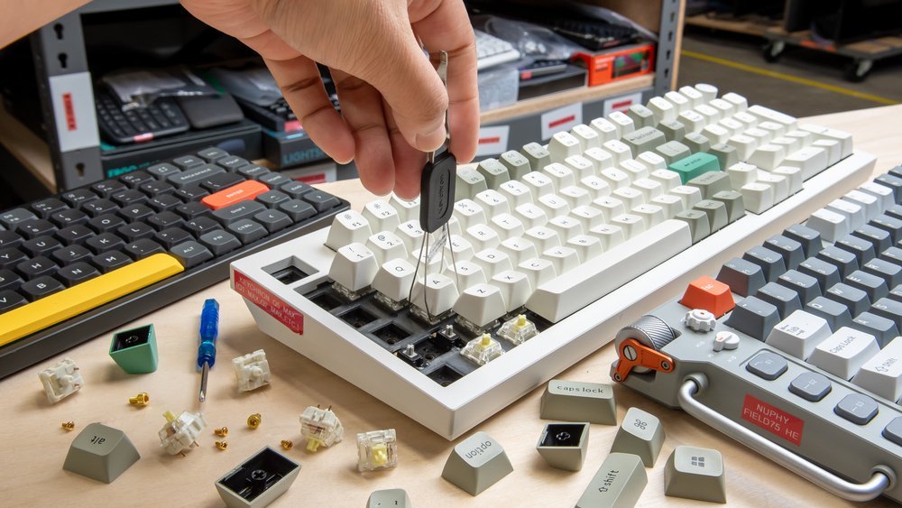A mechanical keyboard sits on a modern desk beside a coffee mug.