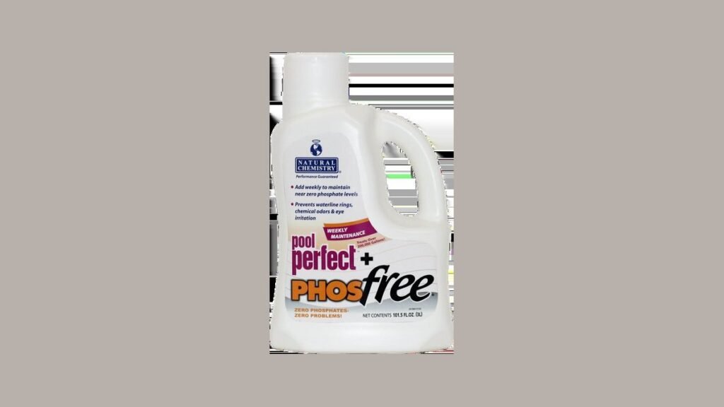 A collection of pool chemicals and maintenance tools placed beside a sparkling clean swimming pool.