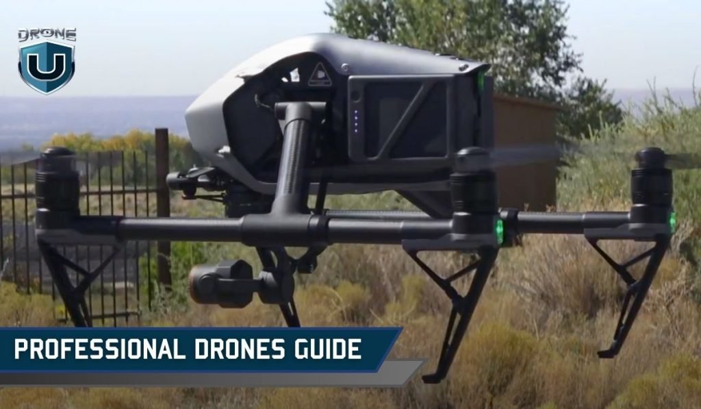 A professional drone hovers over a mountain landscape during a beautiful golden hour.