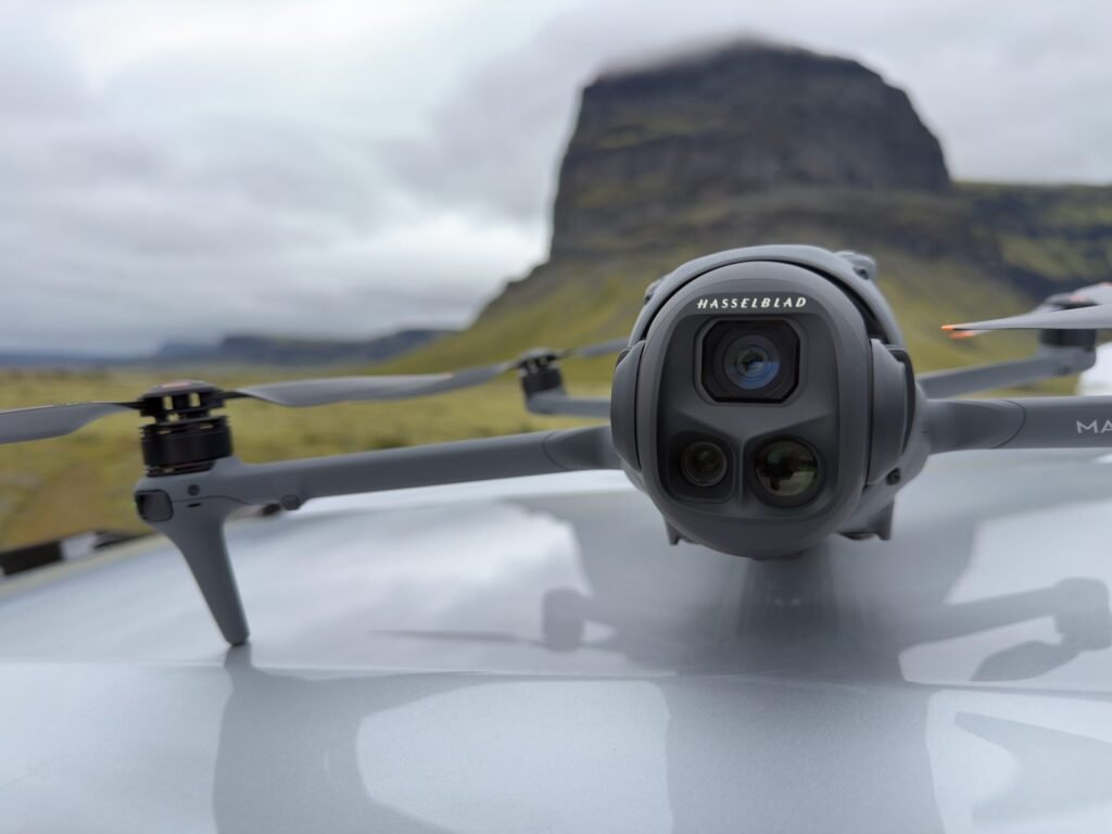 A professional drone sits on a concrete path during the golden hour.