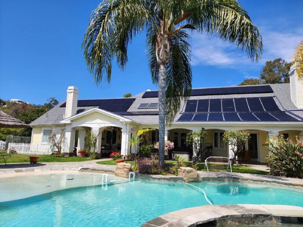 Modern solar panels installed on a residential roof capture clean energy at sunset.