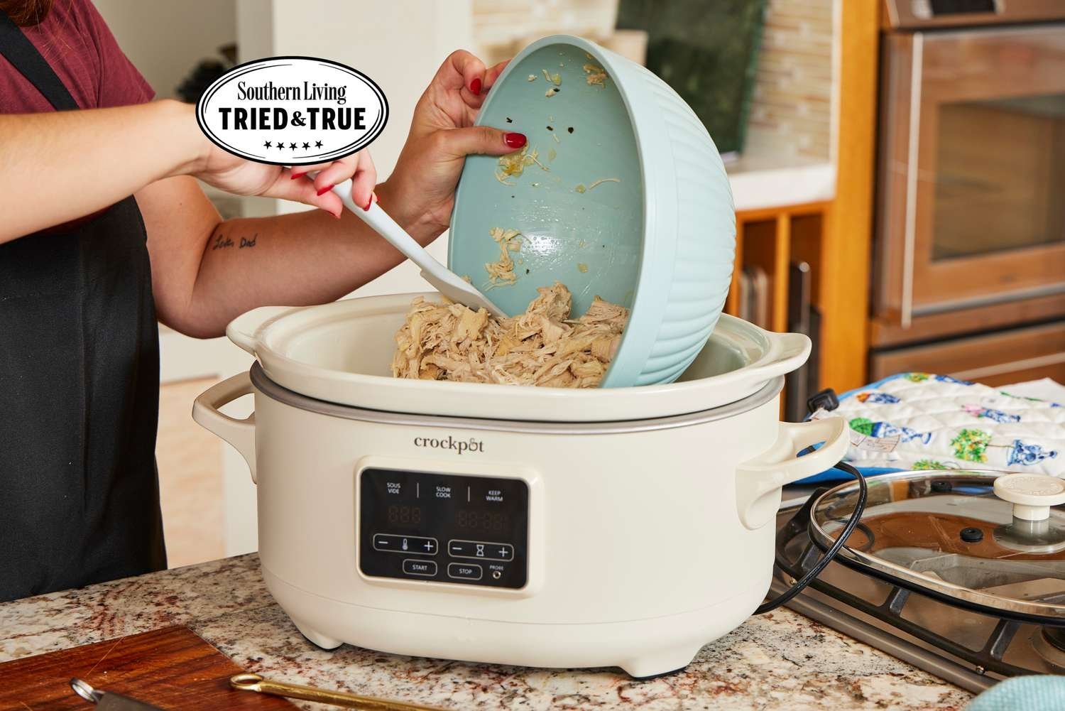 Measuring the counter space for a large slow cooker in a kitchen.