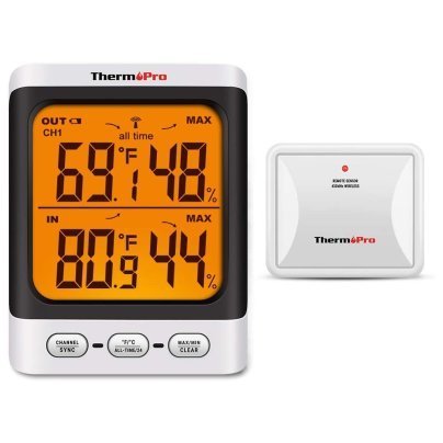 A variety of digital outdoor thermometer models arranged neatly on a stone surface.