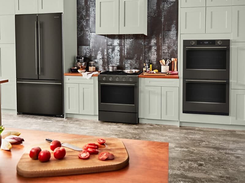 A modern microwave oven placed on a wooden kitchen shelf.