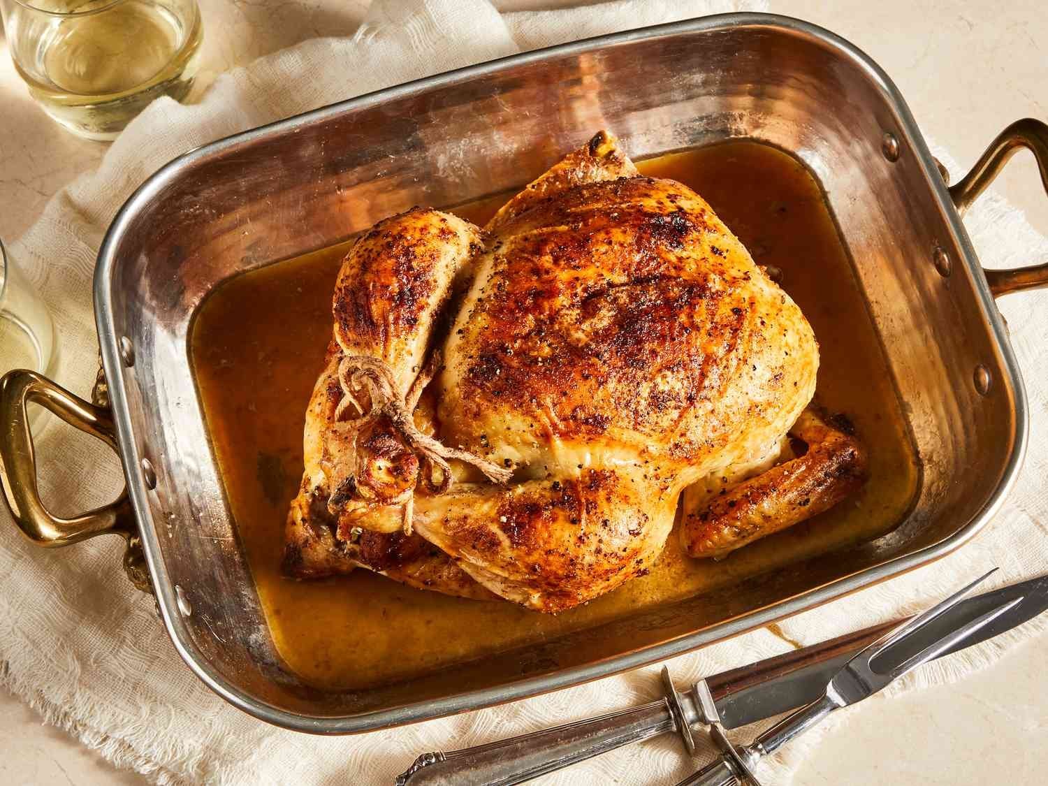 A chicken roasting inside an oven to demonstrate the process of managing the heat.