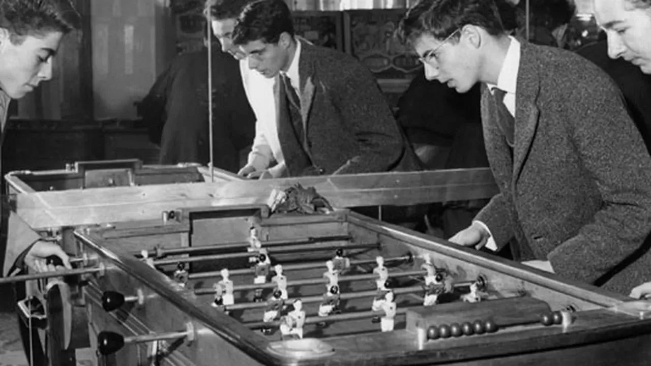 Antique paper cutout football game on a late 1800s wooden desk