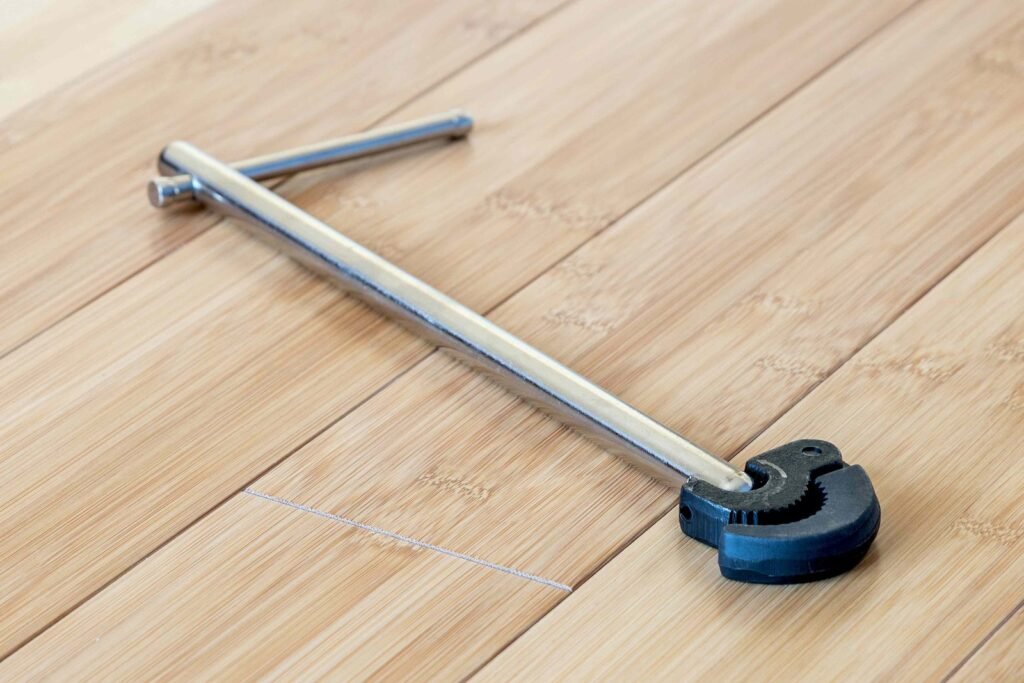 A basin wrench and an adjustable wrench displayed together for a plumbing comparison.
