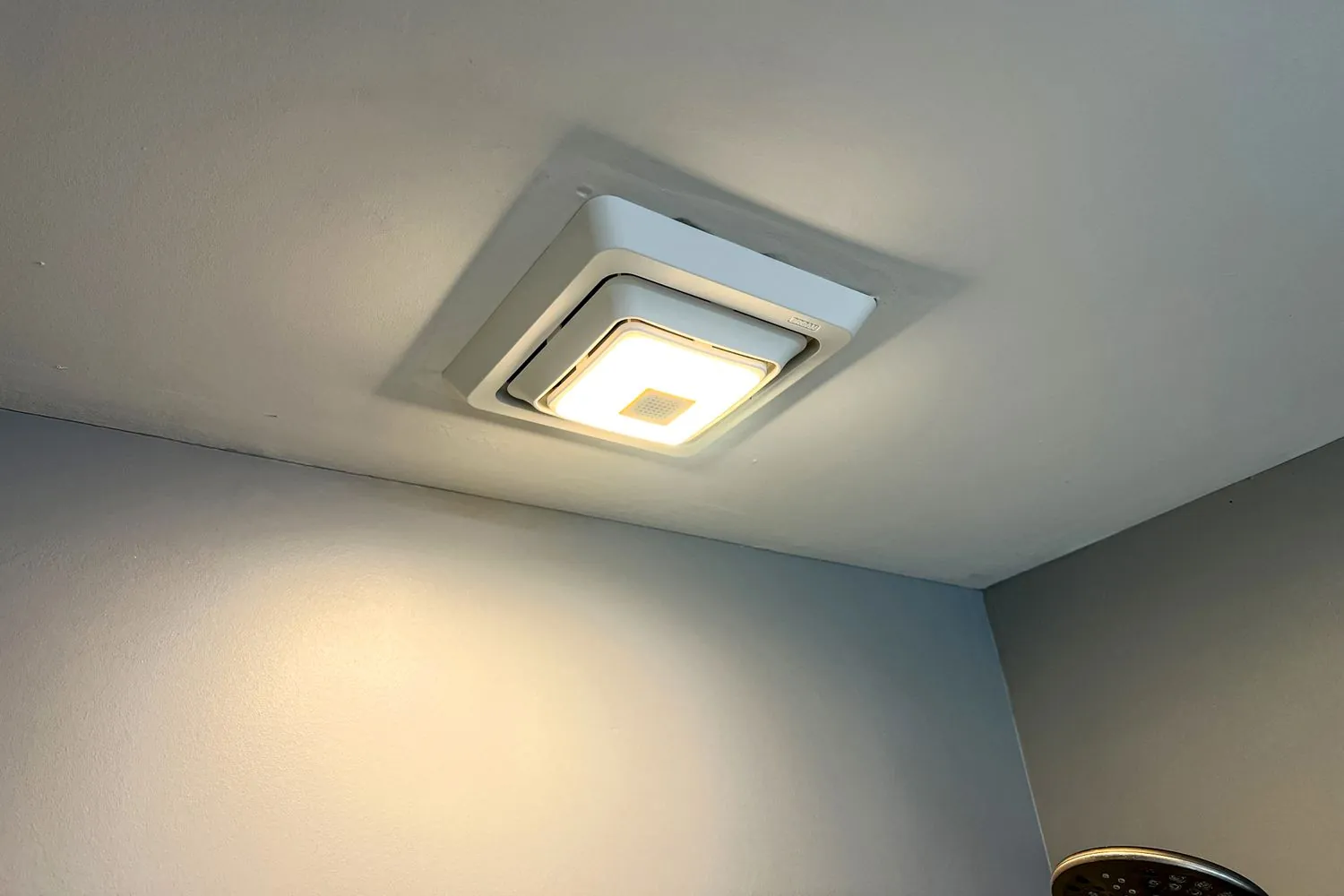 A bathroom exhaust fan installation kit sits on a clean white countertop.