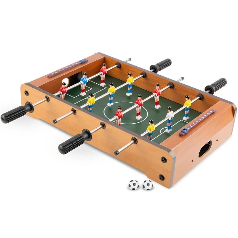 Box of new foosball parts on table near laptop