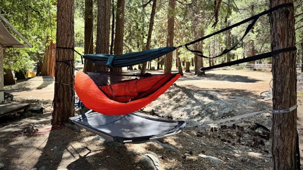camping hammock for side sleepers in a forest clearing with soft light