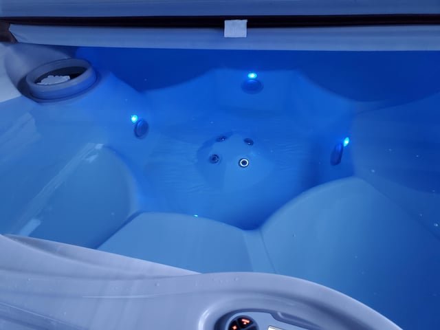 Clean blue swimming pool with dichlor granules and testing tools on the deck.