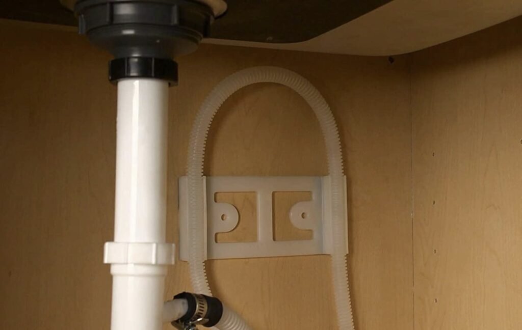 A clean dishwasher drainage setup featuring an air gap and high loop configuration.