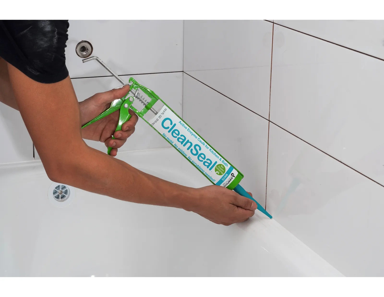 A close-up of cracked and stained caulk along a shower seam.