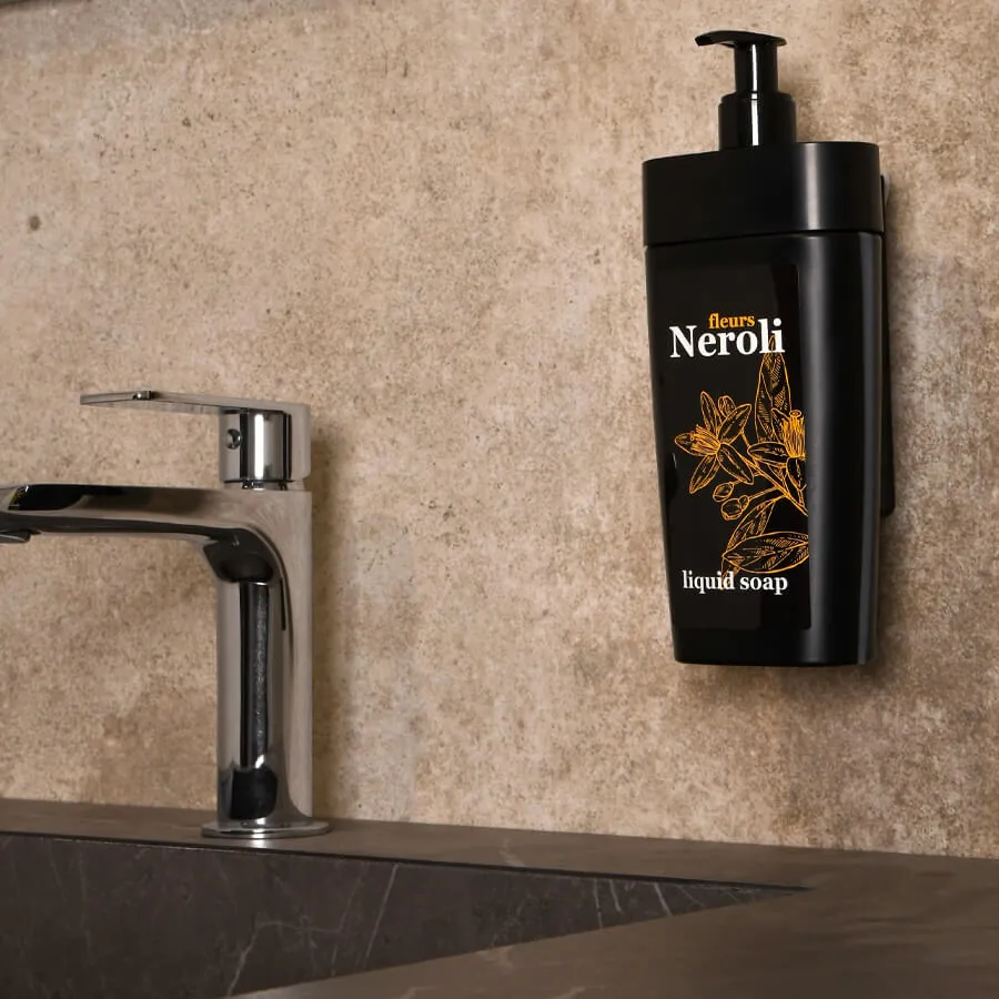 A close-up view of a soap dispenser pump being cleaned to prevent clogging.